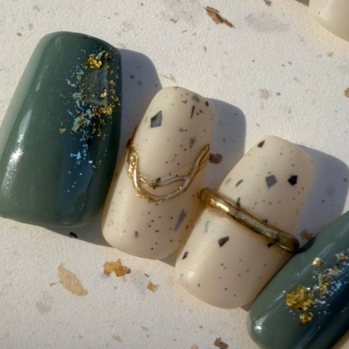 Gilded River Stone press-on nails, close-up of the hand-painted detail