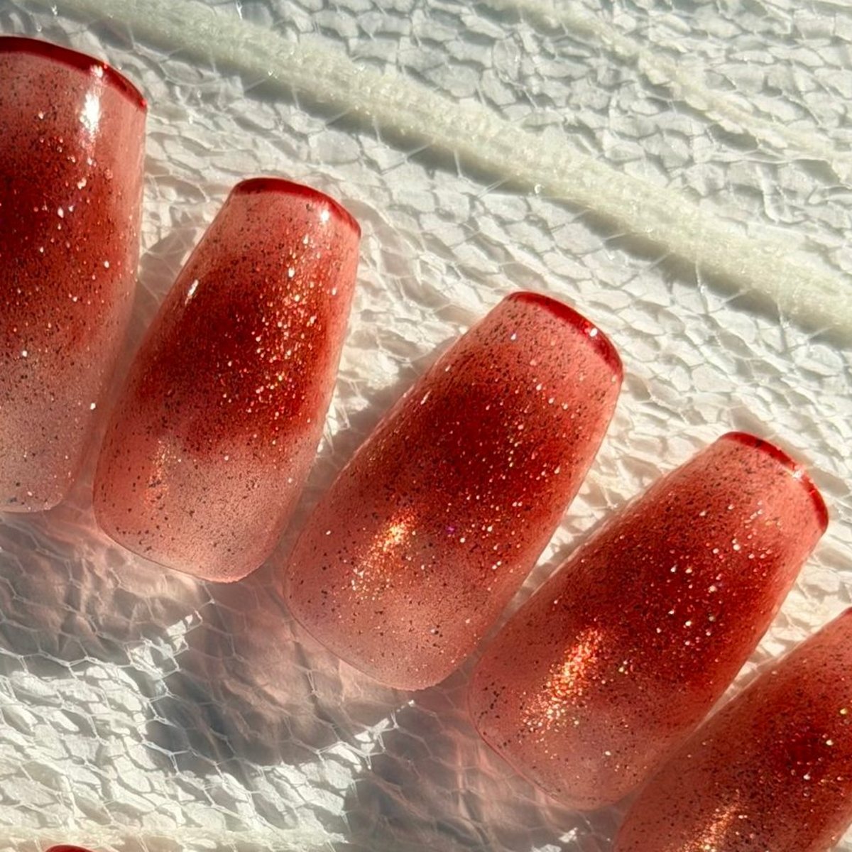 Red Cheek press-on nails, close-up of the hand-painted detail