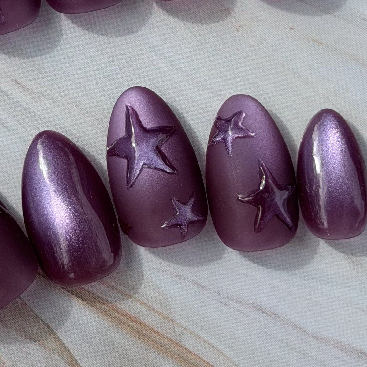 Violet Stars press-on nails, close-up of the hand-painted detail